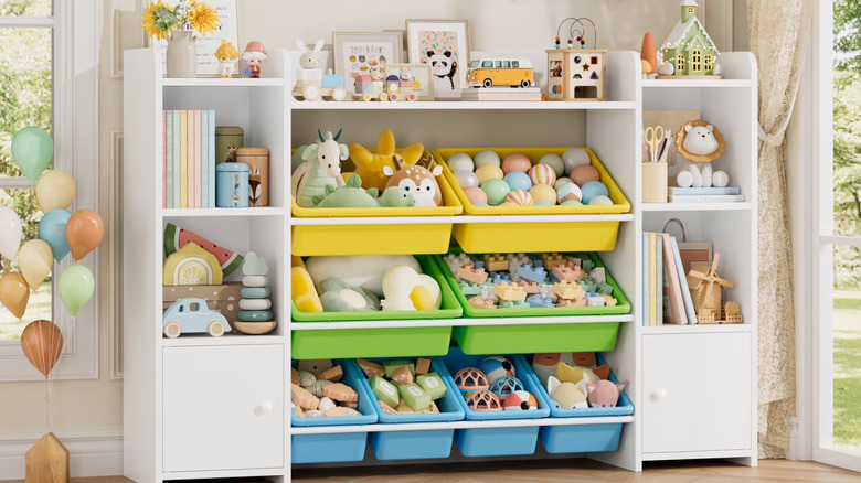A white kids organization station is filled with toys and books