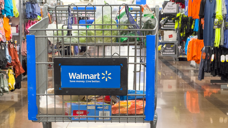 A shopping cart sits in the aisle at Walmart