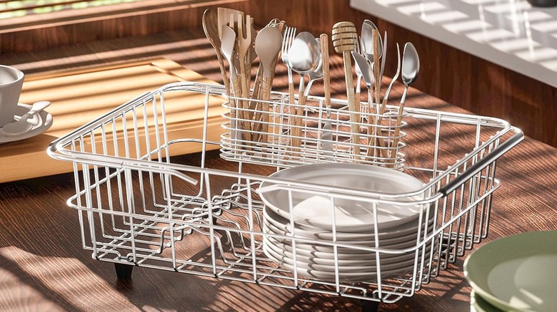 A stainless steel NiuYichee Dish Rack sits on a wooden counter