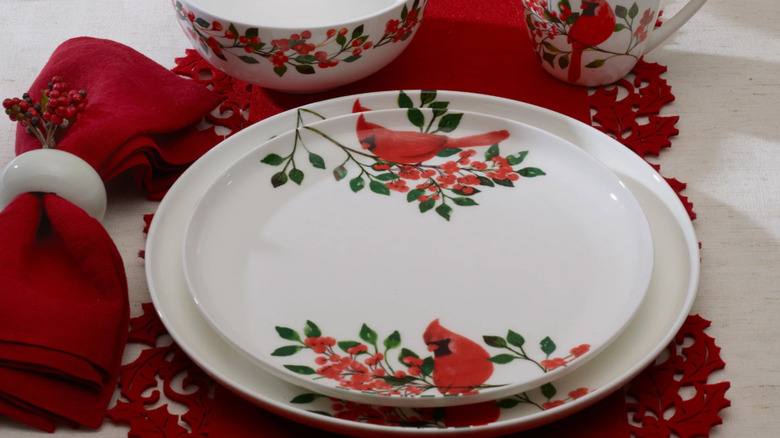 A set of white plates with red cardinals at the top and bottom.