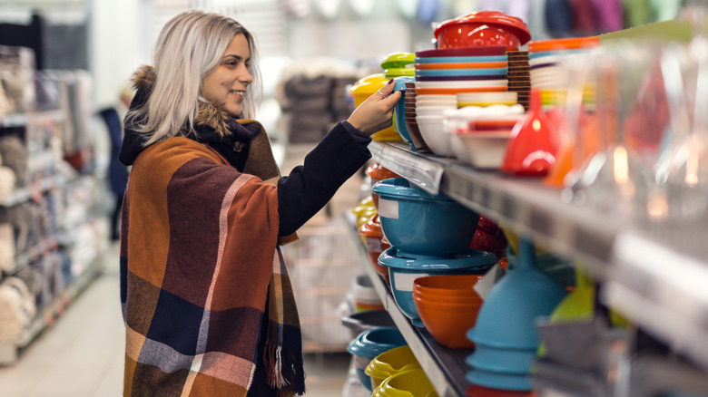 someone shopping for dishware at the thrift store