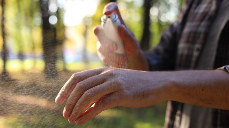 Man sprays hand with spray bottle