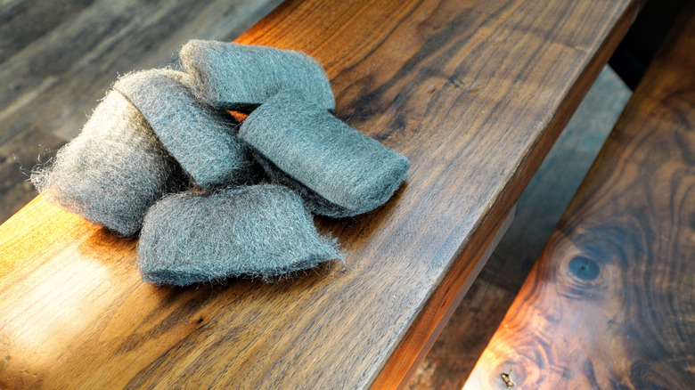 Steel wool on black walnut stairs.