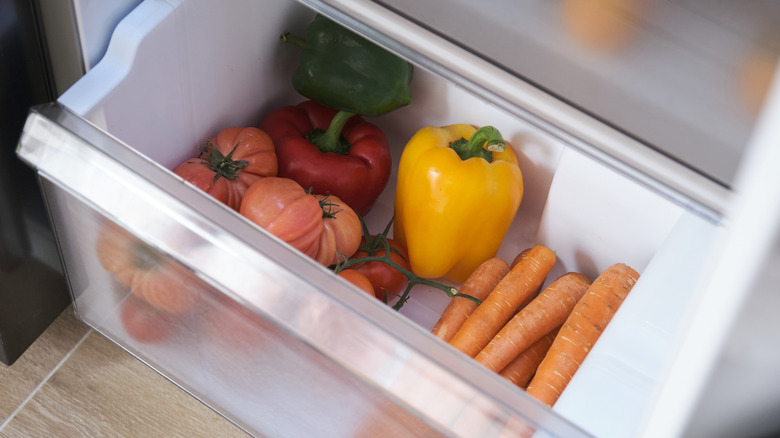 Pale tomatoes in the bottom drawer of a fridge.