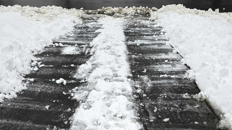 snow and ice on asphalt driveway