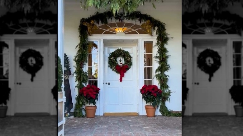Jaclyn Smith's front porch showing wreath, poinsettia vases and a pine bough garland
