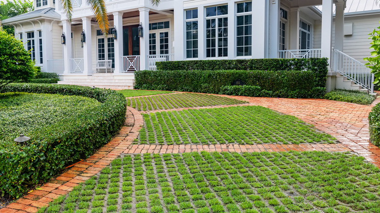 driveway with pavers and grass