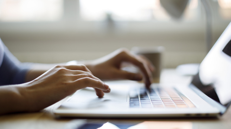Person typing on a laptop