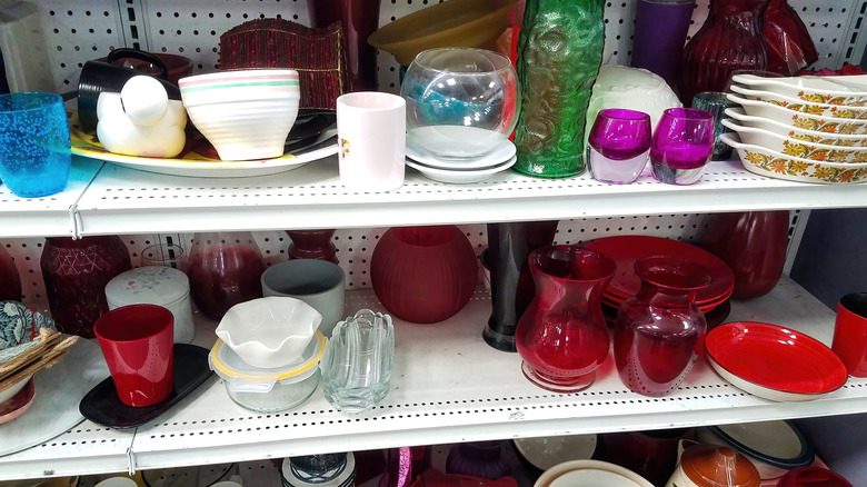 Assorted glassware on the shelves of a thrift store