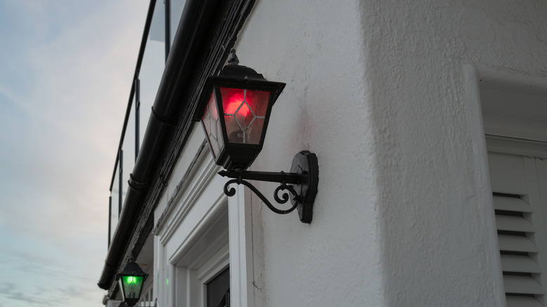 Home with a red bulb in an outdoor lantern