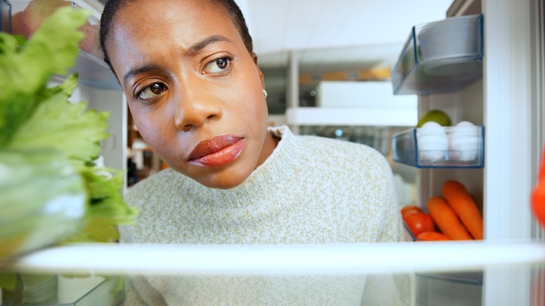 Woman looking at fridge