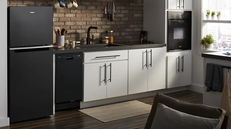 A black fridge in an open layout kitchen