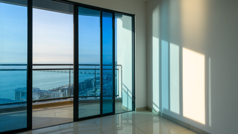 A tinted sliding glass door in a living room
