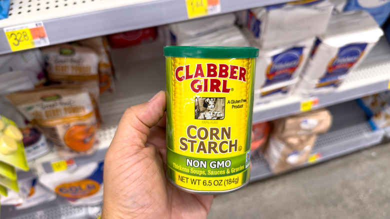 Close up of a person holding container of cornstarch