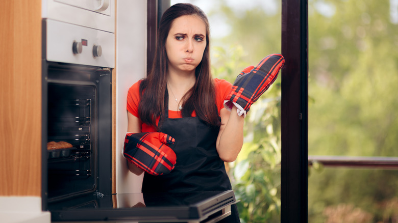 Woman wafting nasty odor away