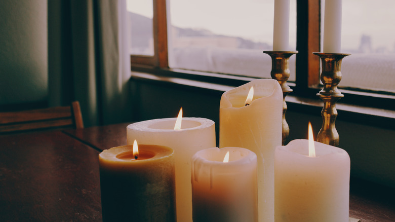 Burning pillar candles on a table