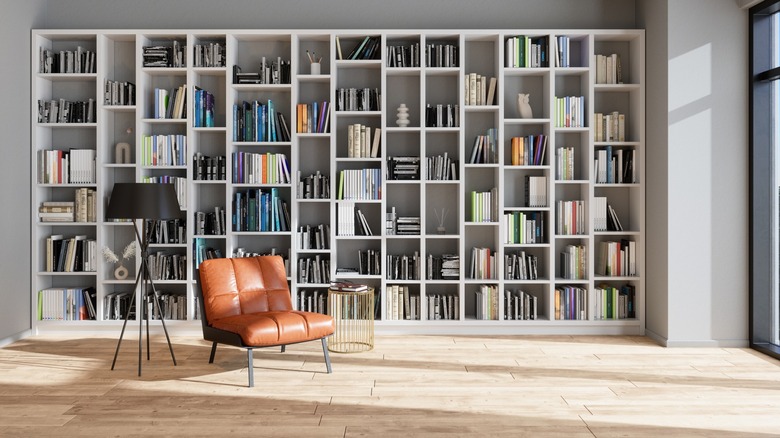 White bookshelf and brown chair