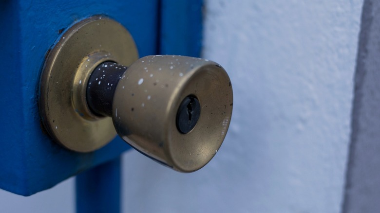 Paint splatter on metal door knob