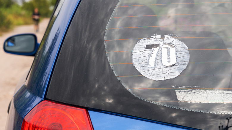 faded sticker on car rear window