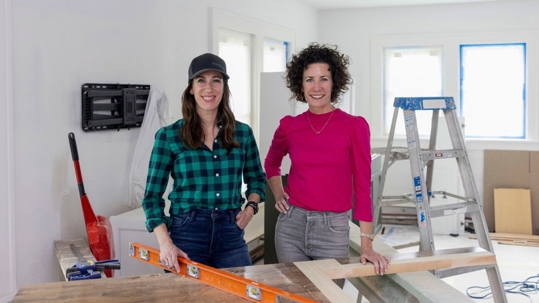 Kirsten Meehan and Lindsey Uselding standing in room being renovated
