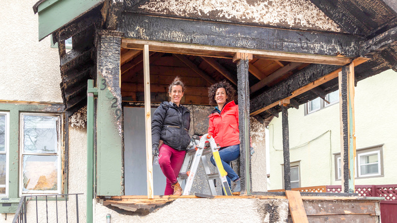 Kirsten Meehan and Lindsey Uselding standing on fire-damaged porch