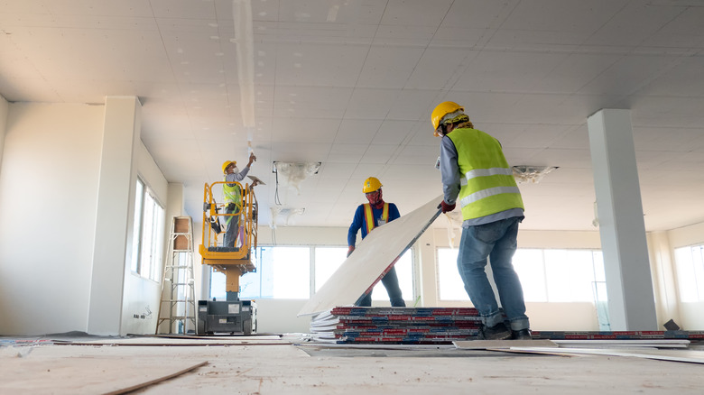 workers renovating house