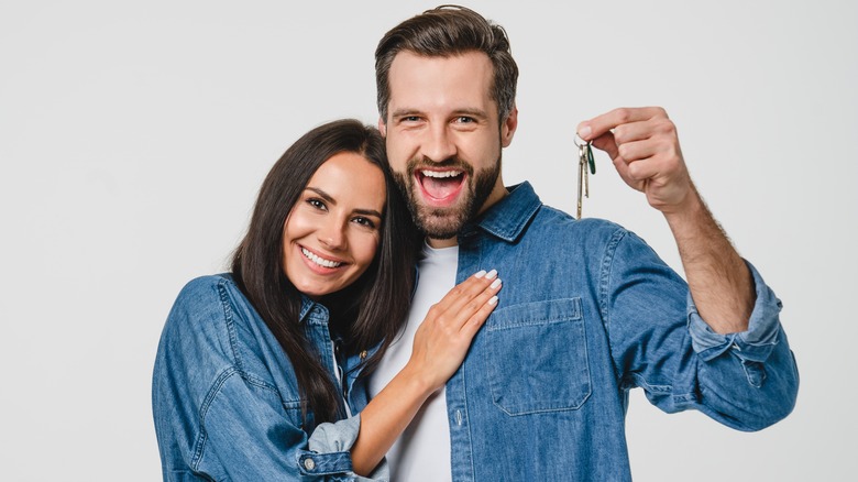 happy couple holding keys