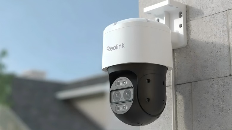 A Reolink TrackMix camera on the side of a home