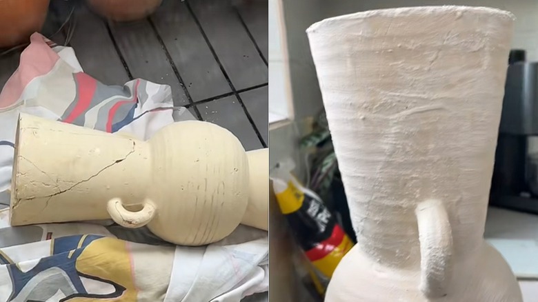 Ceramic vase on its side with pieces glued together and with a coat of plaster of paris over the cracks