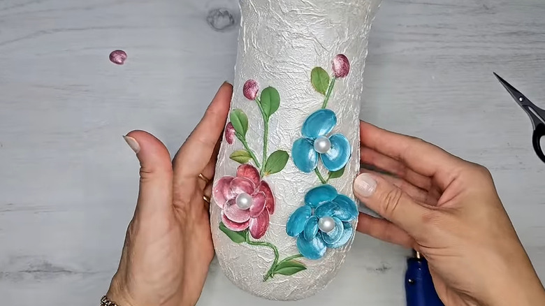 Vase covered in decoupage with pink and blue flowers with pearl accents