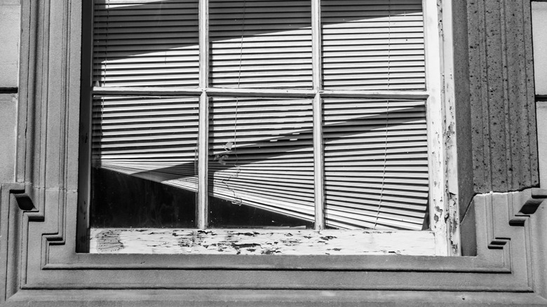 The outside view of crooked window blinds.