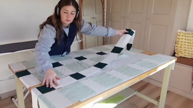 person laying patchwork rows to DIY a shower curtain