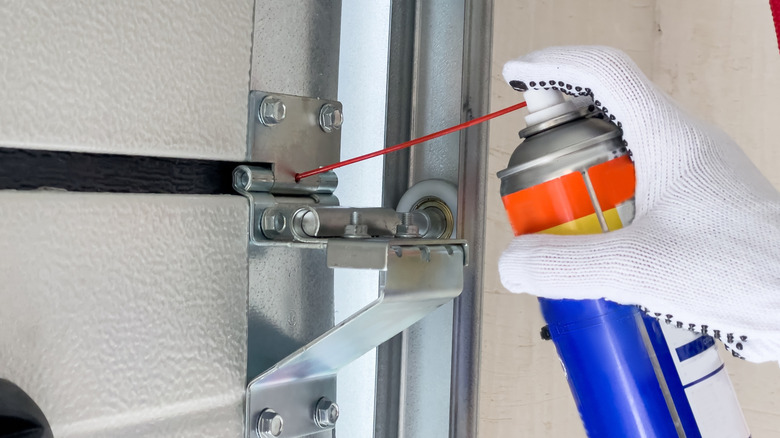 Lubricating a garage door with a specialist spray