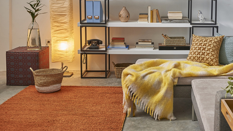 A modern living room with a burnt orange short-pile rug.
