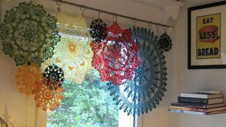 Colorful doilies on a curtain rod
