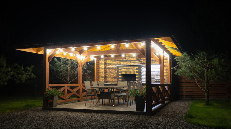 A cozy patio with warm lighting at night