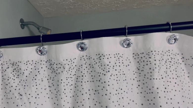 The Sunlit Rhinestone Shower Curtain Hooks used to hang a white shower curtain