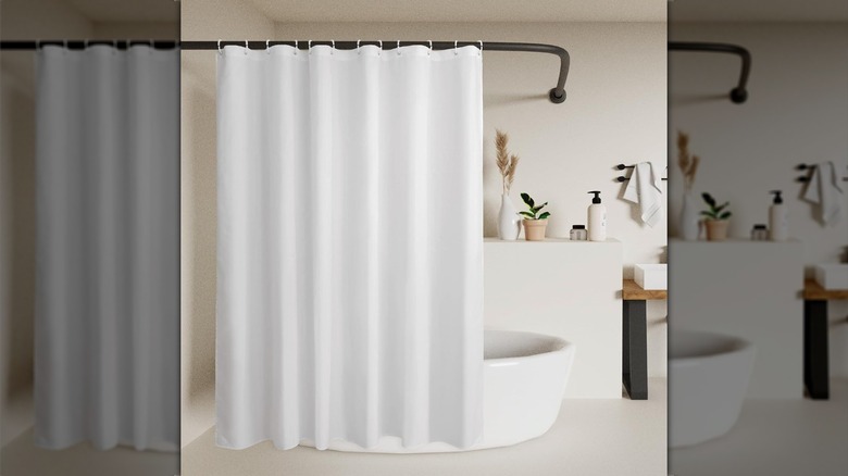 White shower curtain and white bathtub in a contemporary bathroom