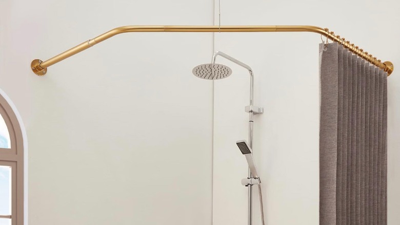 The Mirooyu angled shower curtain rod installed on a corner shower in the bathroom.