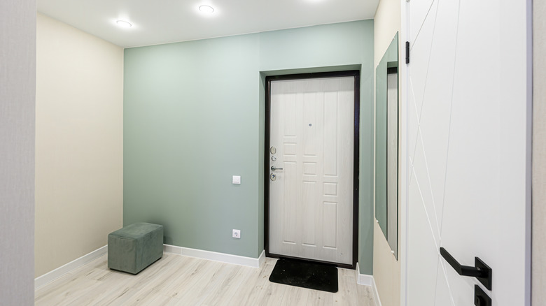 Feature wall in a small room, painted in a light seafoam green