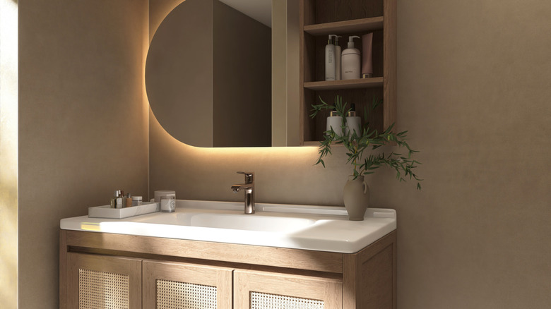 Medium gray-brown paint on a bathroom wall behind sleek, modern vanity.