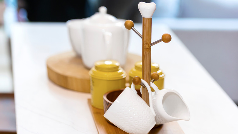 Mug tree with teapot in background