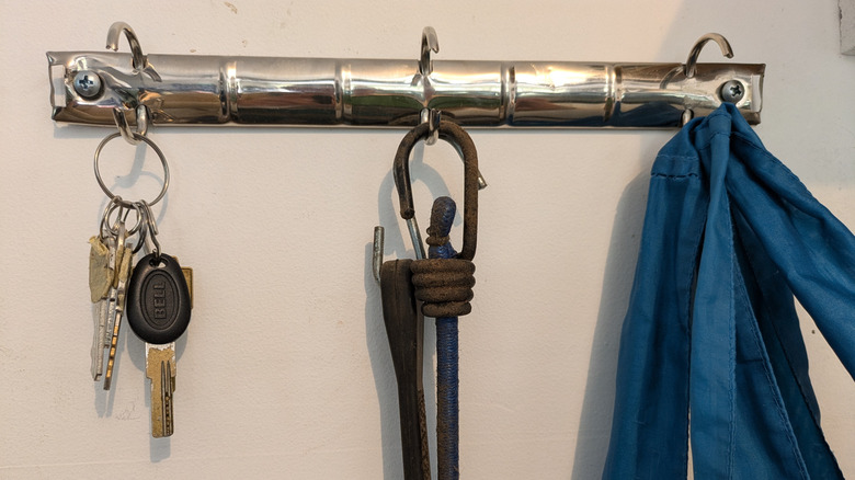 A 3-ring binder spine stands in as hooks for garage storage.