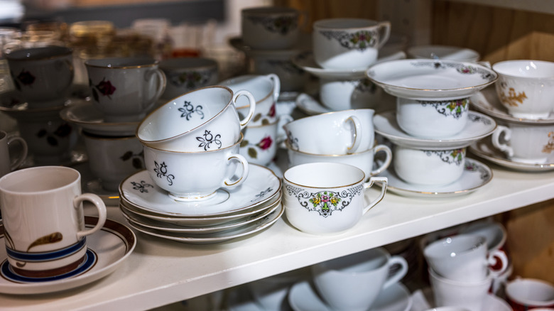 Stacks of vintage tea cups and saucers in the thrift store.
