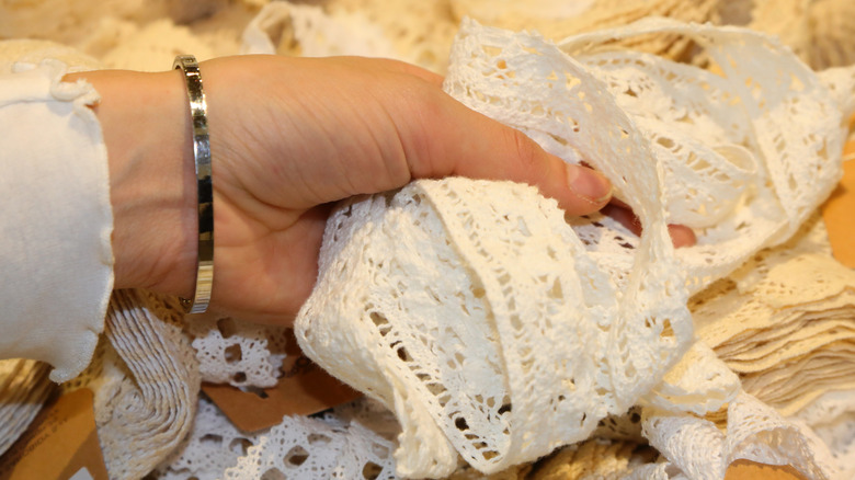 hand clutching vintage doily