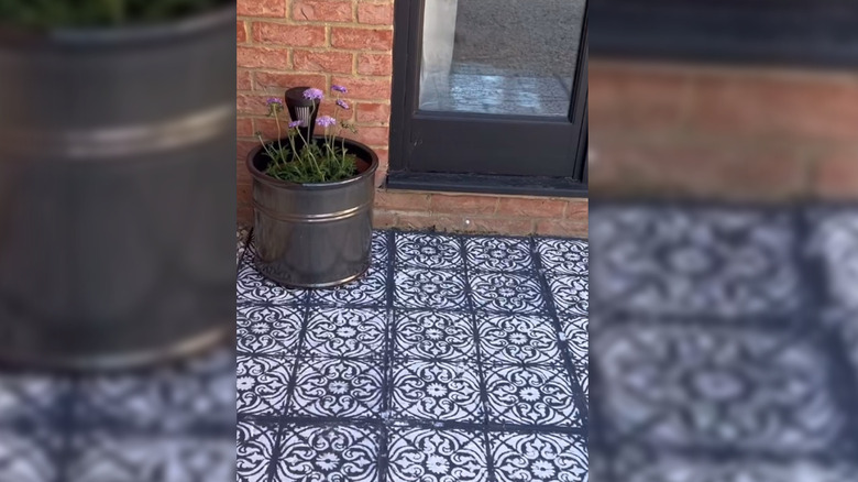Planter sitting atop paint-decorated paver stones