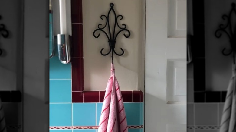 A candle-holder-turned-towel-hook