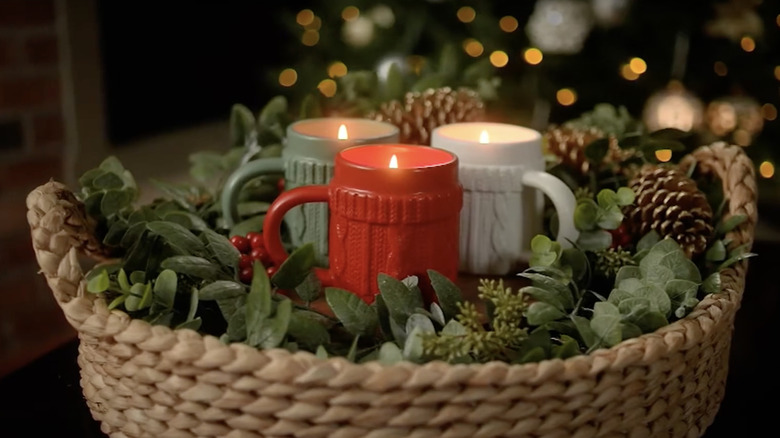 Sweater mugs made into candles and grouped together in a festive centerpiece.