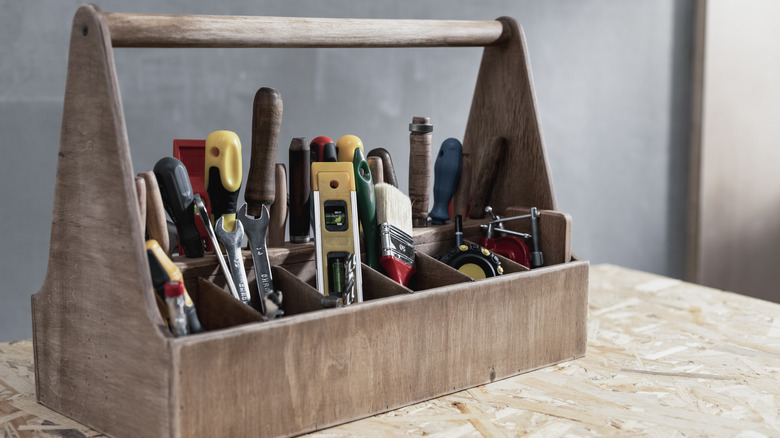 An old wooden toolbox filled with tools