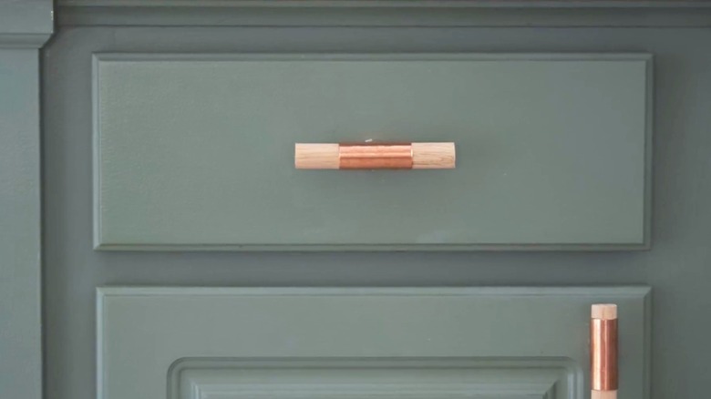 green drawer with DIY pull made with copper tee and wood dowels